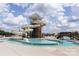 Resort-style community pool with water slides, a splash pad and a tower under a bright blue sky at 1963 Felts Pkwy, Fort Mill, SC 29715