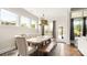 Sunlit dining room features large windows, hardwood floors and stylish furnishings at 1963 Felts Pkwy, Fort Mill, SC 29715