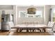 Bright dining area with a large table, tufted chairs, and modern lighting fixtures at 1963 Felts Pkwy, Fort Mill, SC 29715
