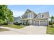 Charming two-story home featuring a three car garage, covered porch and manicured lawn at 1963 Felts Pkwy, Fort Mill, SC 29715