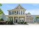 Charming two-story home featuring manicured landscaping, a welcoming front porch, and an attached two-car garage at 1963 Felts Pkwy, Fort Mill, SC 29715