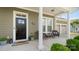 Inviting front porch featuring classic columns, seating area and a black front door at 1963 Felts Pkwy, Fort Mill, SC 29715