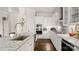 Well-equipped white kitchen featuring stainless steel appliances, granite counters and hardwood floors at 1963 Felts Pkwy, Fort Mill, SC 29715