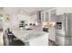Gourmet kitchen boasts a granite island with seating, stainless appliances and white cabinets at 1963 Felts Pkwy, Fort Mill, SC 29715