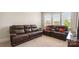 A comfortable living room featuring plush leather sofas, a window, and ample space for relaxation at 1963 Felts Pkwy, Fort Mill, SC 29715