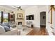 Inviting living room with a fireplace, hardwood floors, and access to staircase at 1963 Felts Pkwy, Fort Mill, SC 29715