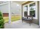 Relaxing covered side porch with comfortable seating and ample natural light at 1963 Felts Pkwy, Fort Mill, SC 29715