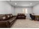 Spacious basement living area with cozy couches, a desk and a window providing natural light at 2037 Birchside Dr, Charlotte, NC 28205