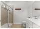 A bathroom view featuring a tile shower with glass door, vanity, toilet and towel hooks at 2037 Birchside Dr, Charlotte, NC 28205