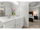 Bright bathroom features a double vanity with a neutral countertop and a view into the bedroom at 2037 Birchside Dr, Charlotte, NC 28205