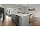Open concept kitchen featuring stainless steel appliances, a kitchen island, and seamless flow to the living area at 2037 Birchside Dr, Charlotte, NC 28205
