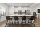 Bright kitchen featuring a large island with seating, stainless appliances, and white cabinets at 2037 Birchside Dr, Charlotte, NC 28205