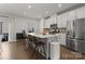Bright, modern kitchen with stainless steel appliances, quartz countertops, and a spacious island with seating at 2037 Birchside Dr, Charlotte, NC 28205