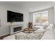 Bright living room features fireplace, large window, and modern furniture at 2037 Birchside Dr, Charlotte, NC 28205