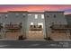 Rear view of townhomes featuring garages, outdoor living space, and neutral siding for a modern look at 2037 Birchside Dr, Charlotte, NC 28205