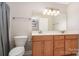 Bathroom featuring a double vanity, toilet and a large mirror with decorative lighting above the sinks at 204 Millwheel Ln, Mount Gilead, NC 27306