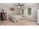 Cozy bedroom with carpet flooring, natural light from windows, and neutral wall color at 204 Millwheel Ln, Mount Gilead, NC 27306