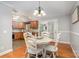 Cozy dining area featuring hardwood floors, a chandelier, and views into the kitchen at 204 Millwheel Ln, Mount Gilead, NC 27306