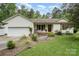 Charming single-story home featuring a well-manicured lawn and attached two-car garage at 204 Millwheel Ln, Mount Gilead, NC 27306