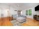Open-concept living room with hardwood floors, a comfortable sofa, and ample natural light at 204 Millwheel Ln, Mount Gilead, NC 27306