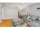 Spacious living room connected to a dining area, featuring a cozy sofa and hardwood floors at 204 Millwheel Ln, Mount Gilead, NC 27306