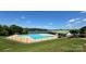 Inviting community pool overlooking a serene lake with lush green surroundings at 204 Millwheel Ln, Mount Gilead, NC 27306