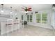 Bright sunroom with tile flooring, multiple windows, and a built-in bar area at 204 Millwheel Ln, Mount Gilead, NC 27306