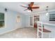 Bright sunroom featuring tile flooring, a ceiling fan, and access to the backyard at 204 Millwheel Ln, Mount Gilead, NC 27306