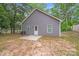 Backyard view with small patio, showcasing home's exterior and landscaping at 205 E Maine Ave, Bessemer City, NC 28016