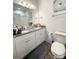 Bathroom features a dual sink vanity with granite countertop and a toilet at 205 E Maine Ave, Bessemer City, NC 28016