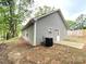 Exterior view of the home showing the back of house, patio, and siding at 205 E Maine Ave, Bessemer City, NC 28016