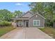 Charming gray home featuring a quaint front porch and well-maintained lawn at 205 E Maine Ave, Bessemer City, NC 28016