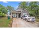 Charming home featuring gray vinyl siding, a well-manicured front lawn, and a paved driveway at 205 E Maine Ave, Bessemer City, NC 28016