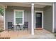 Inviting front porch with seating, black front door, and charming details, enhancing curb appeal at 205 E Maine Ave, Bessemer City, NC 28016