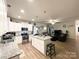 Open-concept kitchen featuring stainless steel appliances, an island, and views of the living room at 205 E Maine Ave, Bessemer City, NC 28016
