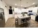 Bright kitchen with stainless steel appliances, white cabinets, and an island with barstool seating at 205 E Maine Ave, Bessemer City, NC 28016