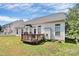 The backyard has a wooden deck, a white fence, and trimmed bushes at 2111 Savoy Pl, Fort Mill, SC 29707