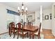 Elegant dining room with hardwood floors, chandelier lighting, and traditional furniture creating a cozy space at 2111 Savoy Pl, Fort Mill, SC 29707
