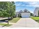 Beautiful home with a long driveway, lush lawn, mature trees, and a charming, inviting facade at 2111 Savoy Pl, Fort Mill, SC 29707
