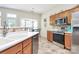 Functional kitchen with wooden cabinets, stainless steel appliances, tile backsplash, and a bright breakfast nook at 2111 Savoy Pl, Fort Mill, SC 29707