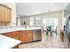Well-lit kitchen featuring wood cabinetry, stainless steel appliances, and an adjacent breakfast nook with bay windows at 2111 Savoy Pl, Fort Mill, SC 29707