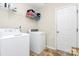 Functional laundry room with modern washer, dryer, shelving and patterned tile flooring at 2111 Savoy Pl, Fort Mill, SC 29707