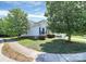 Well-maintained side of house with green lawn, mature trees, and a glimpse of the home's architecture at 2111 Savoy Pl, Fort Mill, SC 29707