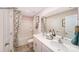 Bathroom featuring a double vanity, a decorative mirror, and a tub with a shower and patterned curtain at 215 Giant Oak Ave, Statesville, NC 28677