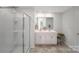 Well-lit bathroom featuring double vanity, glass shower, and modern fixtures at 215 Giant Oak Ave, Statesville, NC 28677