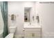 Bathroom featuring a single vanity, a decorative mirror, and a tub with a shower and curtain at 215 Giant Oak Ave, Statesville, NC 28677