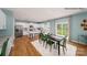 Bright dining area open to the kitchen features white cabinetry and stainless steel appliances at 215 Giant Oak Ave, Statesville, NC 28677