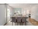 Charming dining area featuring a wooden table, upholstered chairs, and a light-filled ambiance with decorative window treatments at 215 Giant Oak Ave, Statesville, NC 28677