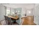 Elegant dining room with hardwood floors, stylish furnishings, and bright natural light through sheer curtains at 215 Giant Oak Ave, Statesville, NC 28677
