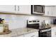 Modern kitchen featuring white cabinets, granite countertops and stainless steel appliances at 215 Giant Oak Ave, Statesville, NC 28677
